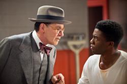 Harrison Ford as Branch Rickey and Chadwick Boseman as Jackie Robinson in 42.