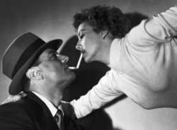 Evelyn Keyes gets a light off Brad Dexter. Evelyn Keyes gets a light off Brad Dexter.