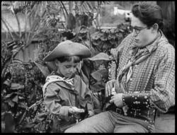 Harold Lloyd teaches a toddler how to roll a cigarette in Billy Blazes, Esq..