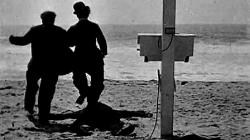 Billy Armstrong and Charlie Chaplin in silhouette by the sea. Billy Armstrong and Charlie Chaplin in silhouette by the sea.