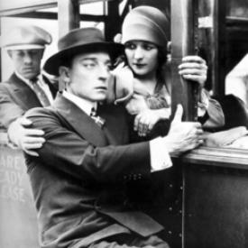 Buster Keaton rides outside the bus in The Cameraman.