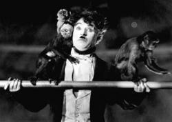 Charlie Chaplin and several monkeys in The Circus.