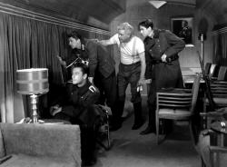 Errol Flynn, Ronald Reagan, Alan Hale and Ronald Sinclair hitch a ride in Goring's personal train car in Desperate Journey.