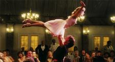 Jennifer Grey, having the time of her life, as Patrick Swayze tries not to drop her.