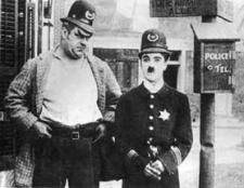 Eric Campbell and Charles Chaplin in Easy Street.