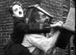 Charlie Chaplin finds a creative way to deal with a bully in Easy Street.