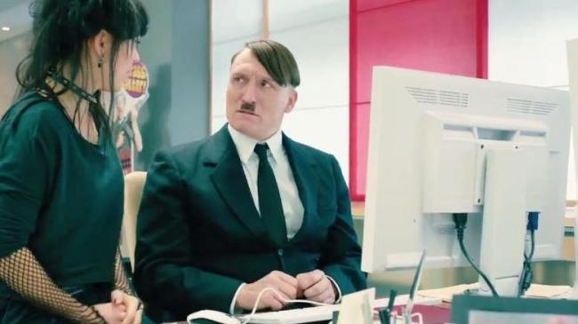 Oliver Masucci as Adolf Hitler, learning how easy contemporary technology makes it to reach a large audience in Look Who's Talking