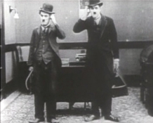 Charlie Chaplin invents the mirror image gag.