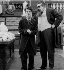 Charles Chaplin and Eric Campbell in The Floorwalker.