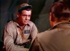 Robert Ryan talks it over with John Wayne.