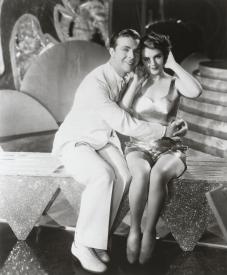Dick Powell has plans if he can get that metal top off Ruby Keeler. Dick Powell has plans if he can get that metal top off Ruby Keeler.
