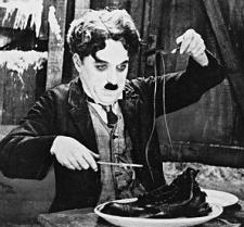 Charlie Chaplin eats his boot in The Gold Rush. Charlie Chaplin eats his boot in The Gold Rush.