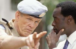 Nick Nolte and Don Cheadle in Hotel Rwanda.