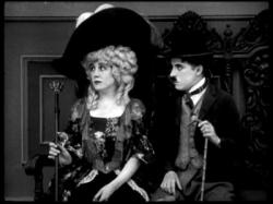 Edna Purviance and Charles Chaplin in The Idle Rich