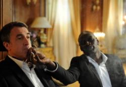 Omar Sy helps Francois Cluzet relax in The Intouchables.