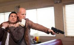 Joseph Gordon-Levitt and Bruce Willis in Looper. Joseph Gordon-Levitt and Bruce Willis in Looper.