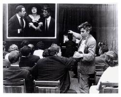 Mack Sennett and Fatty Arbuckle in the audience while Mabel Normand is on the big screen.