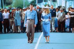 Jim Carrey and Laure Holden take a stroll while the entire town follows in The Majestic.