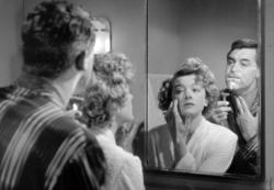 Cary Grant and Myrna Loy share a mirror in Mr. Blandings Builds His Dream House.