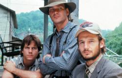 Bill Paxton, Patrick Swayze, and Liam Neeson play brothers in Next of Kin. Bill Paxton, Patrick Swayze, and Liam Neeson play brothers in Next of Kin.