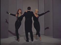 Rita Hayworth and Kim Novak dance around Frank Sinatra in Pal Joey.