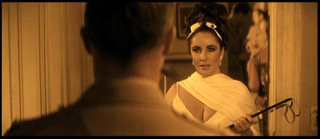 Marlon Brando about to get whipped by Elizabeth Taylor in Reflections in a Golden Eye