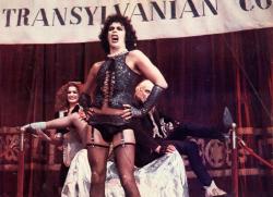 Frank-N-Furter sings while Magenta and Riff Raff look on. Frank-N-Furter sings while Magenta and Riff Raff look on.