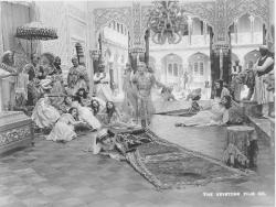 Gloria Swanson, under the carpet, and Bobby Vernon, dancing in drag in The Sultan's Wife. Gloria Swanson, under the carpet, and Bobby Vernon, dancing in drag in The Sultan's Wife.