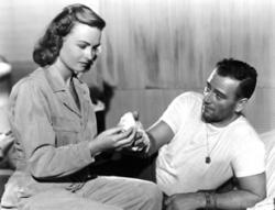Donna Reed nurses John Wayne. Donna Reed nurses John Wayne.