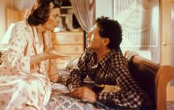 Ann Bancroft and Harvey Fierstein in Torch Song Trilogy. You cannot see them in this picture but Bancroft is wearing bunny slippers.