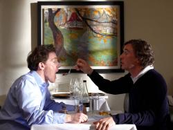 Steve Coogan offers Rob Brydon a bite of his dessert in The Trip.