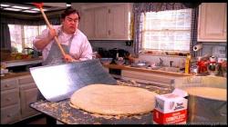 John Candy cooks breakfast as Uncle Buck.