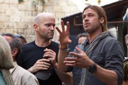 Director Marc Forster seeming to get direction from Brad Pitt during the production of World War Z