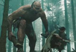 A giant Cyclops chases Sam Worthington as Perseus in Wrath of the Titans.