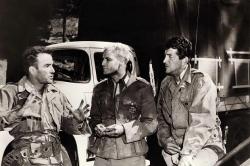 Montgomery Clift, Marlon Brando, and Dean Martin talk during a break in filming The Young Lions. Montgomery Clift, Marlon Brando, and Dean Martin talk during a break in filming The Young Lions.